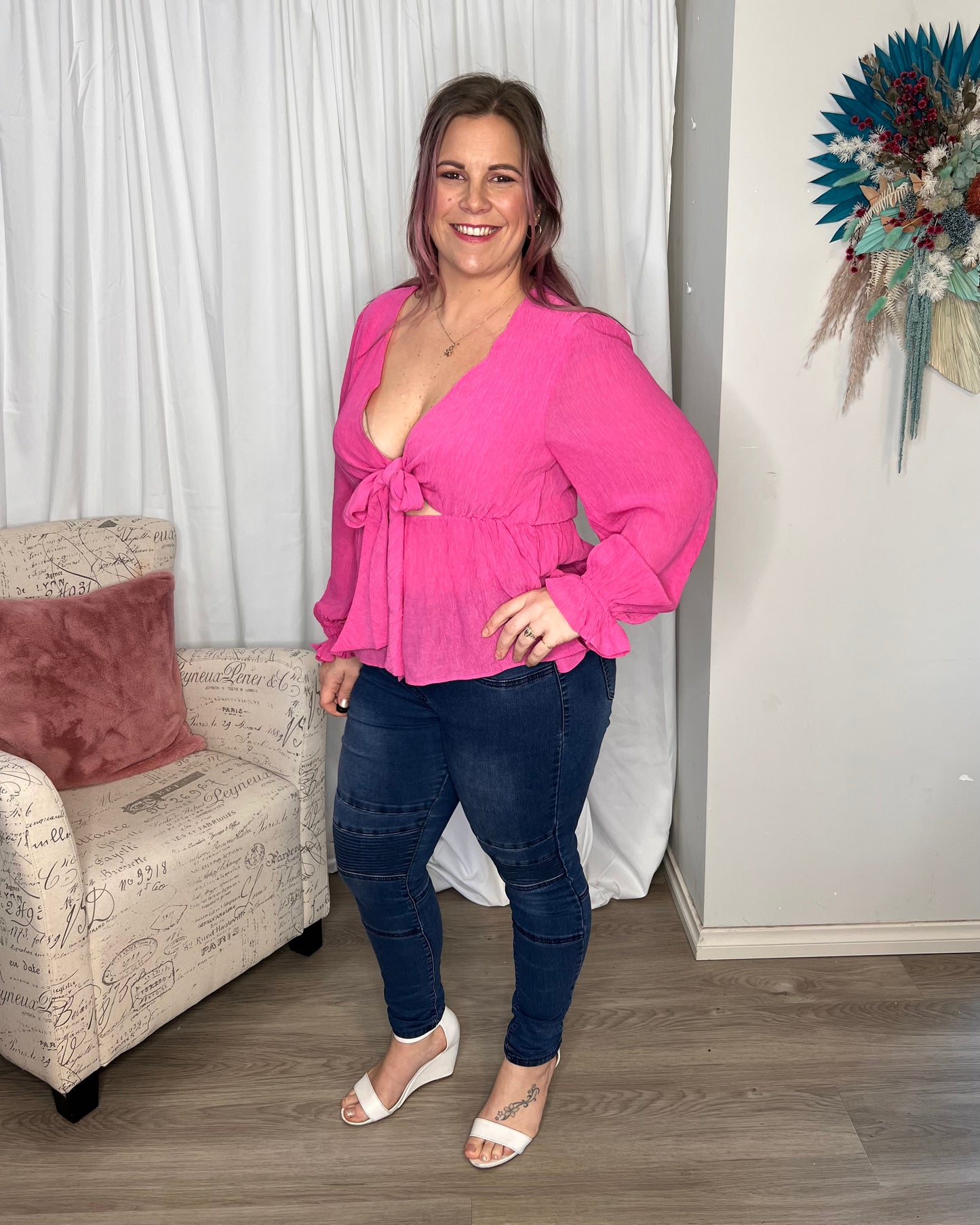 Lillian Tie Top | Sass Clothing |
The Lillian Tie Top is a must for your Barbiecore style! Its fun balloon sleeves, elastic cuffs, and flirty tie front make it the perfect piece for the season. No