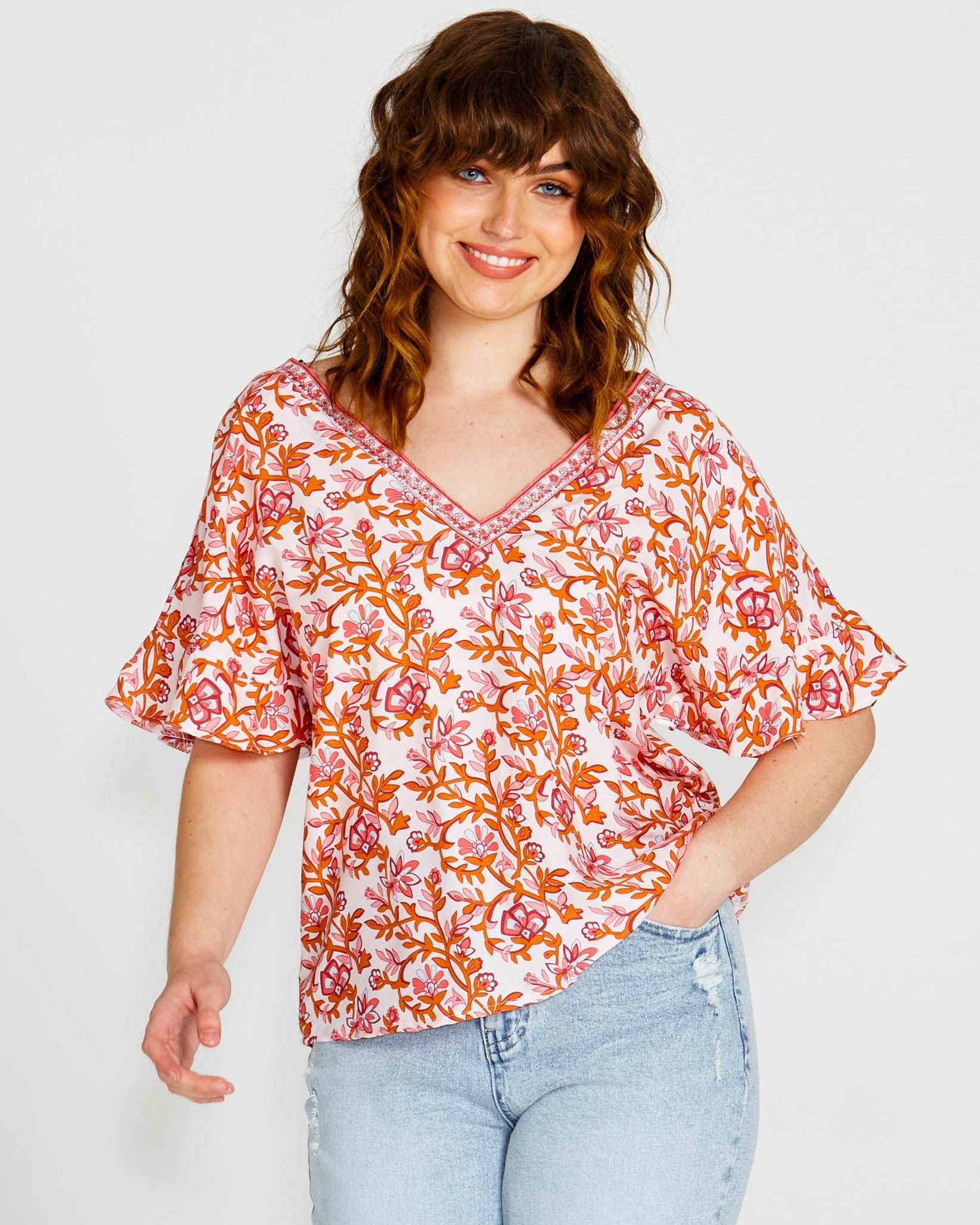 **NEW** Ashley V-Neck Top: Elevate your casual chic with the Ashley V-Neck Top! Designed for a relaxed fit, this top features a flattering V neckline and playful fluted short sleeves for a tou - Ciao Bella Dresses - Sass Clothing