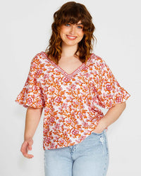 **NEW** Ashley V-Neck Top: Elevate your casual chic with the Ashley V-Neck Top! Designed for a relaxed fit, this top features a flattering V neckline and playful fluted short sleeves for a tou - Ciao Bella Dresses - Sass Clothing