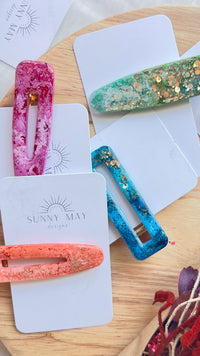 Sunny May Hair Clips: These hair slides are handmade from a delightful mix of colours and glitter, creating the perfect mix of vibrant colour and shine to brighten up your outfit
These go - Ciao Bella Dresses 