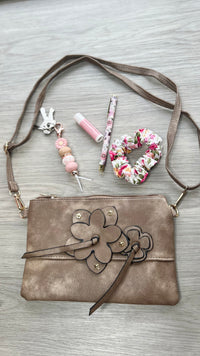 *NEW* Crossbody Bag - Flower Zip: Enjoy effortless style with the Flower Zip Crossbody Bag! Whether you prefer a dark hue or something more subtle, we have the perfect shade for you. This purse is su - Ciao Bella Dresses