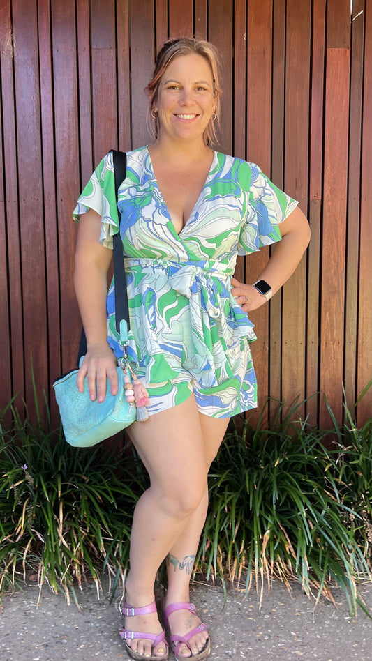 *NEW* Lynette Playsuit - Blue Floral | Sao by Dee | The Lynette Playsuit features a gorgeous V neckline, attached waist tie to tie to the front and a tiered ruffle overlay on the bottom half. A reason to love a playsu