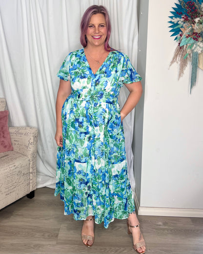Vina Midi Dress: 
The Vina Dress features a soft floral print in watercolour blue and gold thread, with flutter sleeves and a shirred waist band creating a stunning silhouette
Featur - Ciao Bella Dresses 