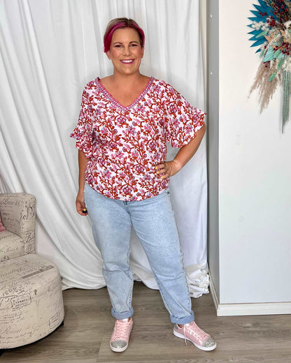 **NEW** Ashley V-Neck Top: Elevate your casual chic with the Ashley V-Neck Top! Designed for a relaxed fit, this top features a flattering V neckline and playful fluted short sleeves for a tou - Ciao Bella Dresses - Sass Clothing