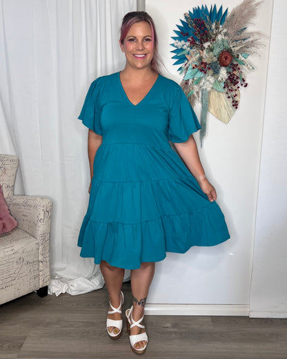 ***NEW*** Cressida Dress: Introducing the Cressida Dress your carefree chic essential! With a V-neck, flutter sleeves, a relaxed tiered body, and pockets for added flair, this dress effortles - Ciao Bella Dresses 