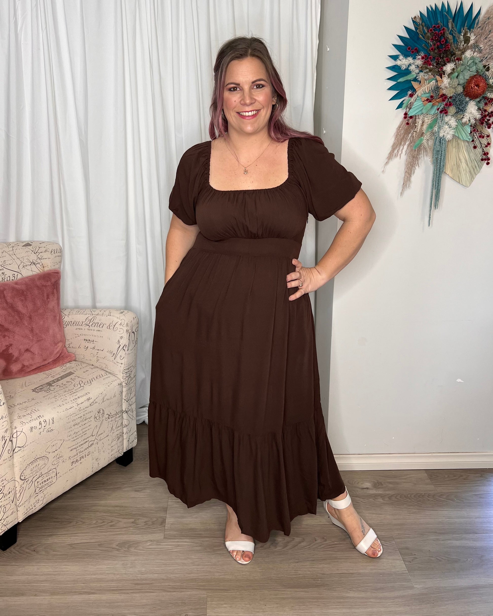 Yasmin Midi Dress - Brown | Sass Clothing | Introducing the Yasmin Frill Hem Midi Dress! With its flirty frill hem and elasticated square neckline, it exudes confidence and grace. The back shirred panel ensure