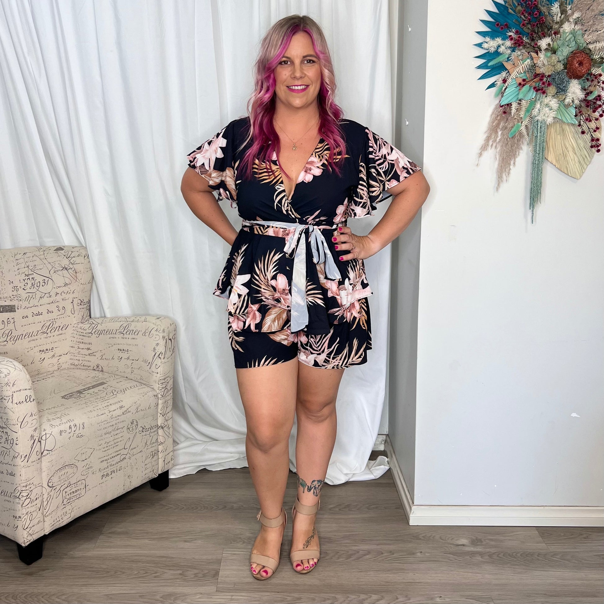 *NEW* Lynette Playsuit - Hot Pink Floral | Sao by Dee | The Lynette Playsuit features a gorgeous V neckline, attached waist tie to tie to the front and a tiered ruffle overlay on the bottom half. A reason to love a playsu