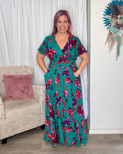 Liliana Maxi Dress: The Liliana Dress features a rich green background with a gorgeous deep red rose patten in one of our most popular shapes. This stunning dress features a thick shirr - Ciao Bella Dresses 