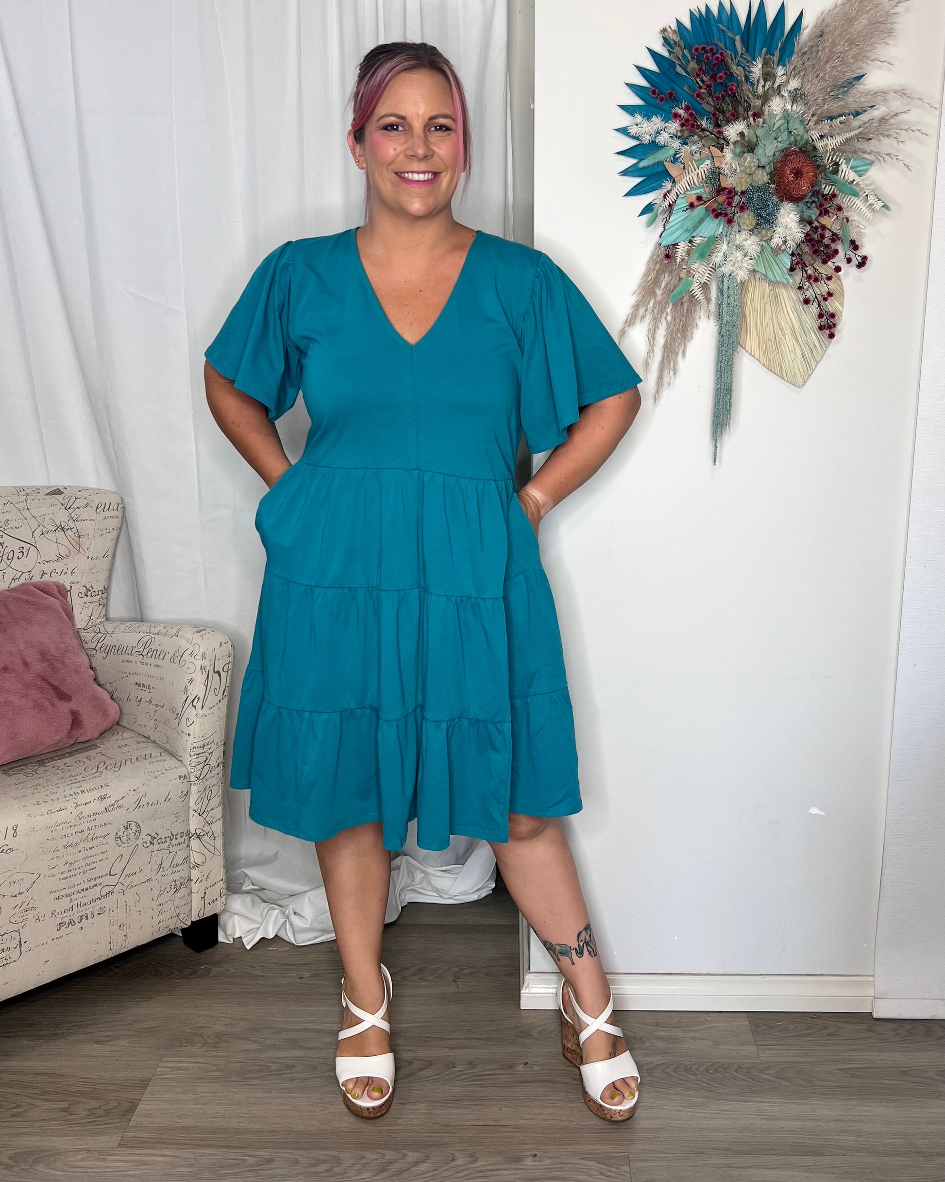 Cressida Dress - Turquoise | Betty Basics | Introducing the Cressida Dress your carefree chic essential! With a V-neck, flutter sleeves, a relaxed tiered body, and pockets for added flair, this dress effortles