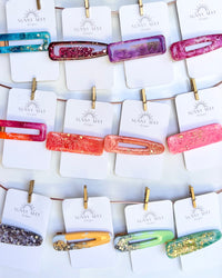Sunny May Hair Clips: These hair slides are handmade from a delightful mix of colours and glitter, creating the perfect mix of vibrant colour and shine to brighten up your outfit
These go - Ciao Bella Dresses 