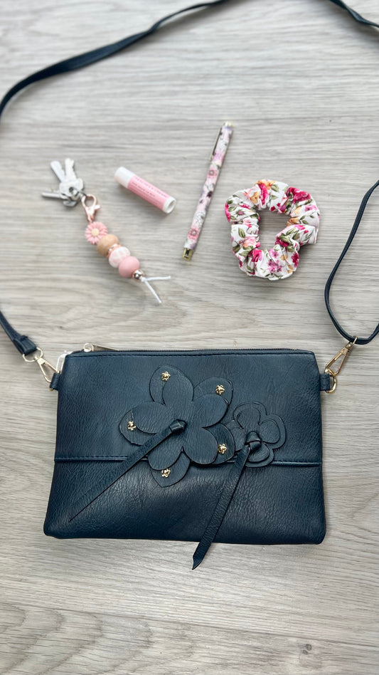 *NEW* Crossbody Bag - Flower Zip: Enjoy effortless style with the Flower Zip Crossbody Bag! Whether you prefer a dark hue or something more subtle, we have the perfect shade for you. This purse is su - Ciao Bella Dresses