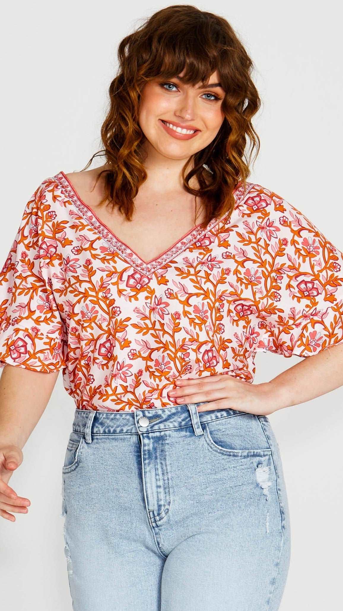 **NEW** Ashley V-Neck Top: Elevate your casual chic with the Ashley V-Neck Top! Designed for a relaxed fit, this top features a flattering V neckline and playful fluted short sleeves for a tou - Ciao Bella Dresses - Sass Clothing