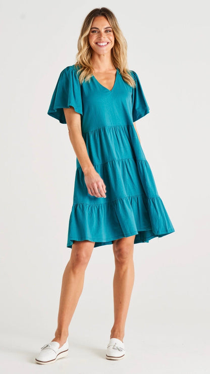 Cressida Dress - Turquoise | Betty Basics | Introducing the Cressida Dress your carefree chic essential! With a V-neck, flutter sleeves, a relaxed tiered body, and pockets for added flair, this dress effortles