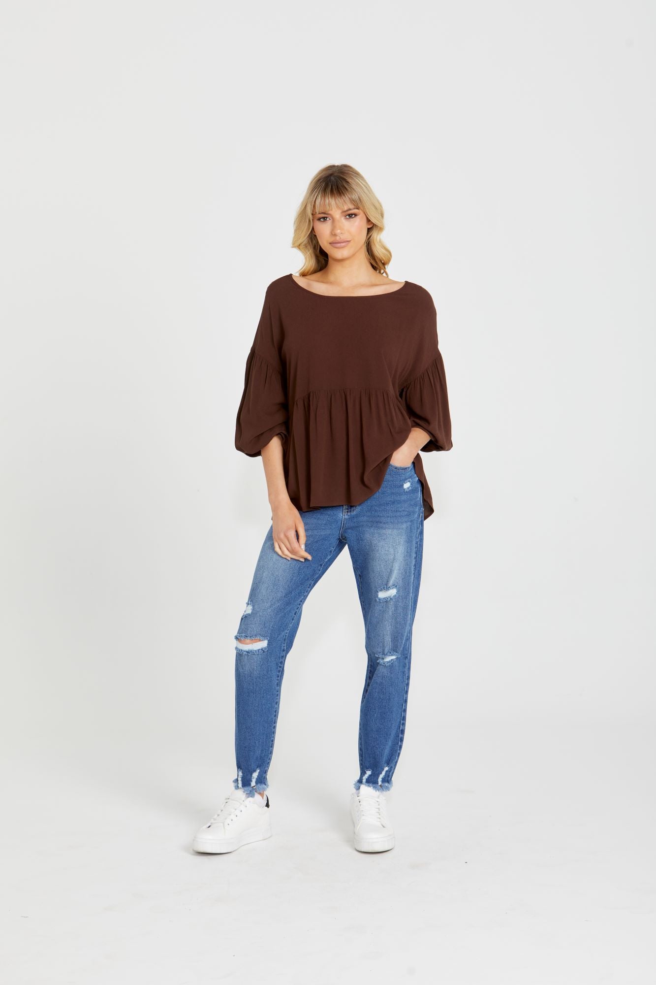 Yasmin Bubble Sleeve Top - Brown | Sass Clothing |  
With its trendy V-neckline and dropped shoulder into bubble sleeves, this top exudes effortless style. The relaxed fit offers ultimate comfort, while the back keyh