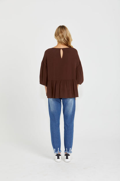 Yasmin Bubble Sleeve Top - Brown | Sass Clothing |  
With its trendy V-neckline and dropped shoulder into bubble sleeves, this top exudes effortless style. The relaxed fit offers ultimate comfort, while the back keyh