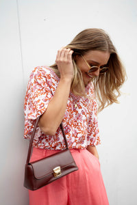 **NEW** Ashley V-Neck Top: Elevate your casual chic with the Ashley V-Neck Top! Designed for a relaxed fit, this top features a flattering V neckline and playful fluted short sleeves for a tou - Ciao Bella Dresses - Sass Clothing