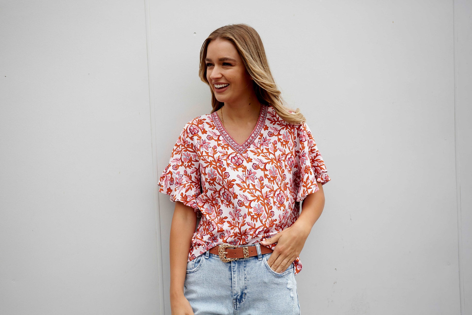 **NEW** Ashley V-Neck Top: Elevate your casual chic with the Ashley V-Neck Top! Designed for a relaxed fit, this top features a flattering V neckline and playful fluted short sleeves for a tou - Ciao Bella Dresses - Sass Clothing