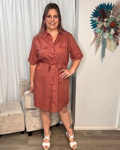 Aspen Dress: 
The Aspen Dress is a versatile shirt dress made from 100% cotton. With a matching belt and convenient pockets, this short dress features a chic high-low hem and is  - Ciao Bella Dresses - Mylk the Label