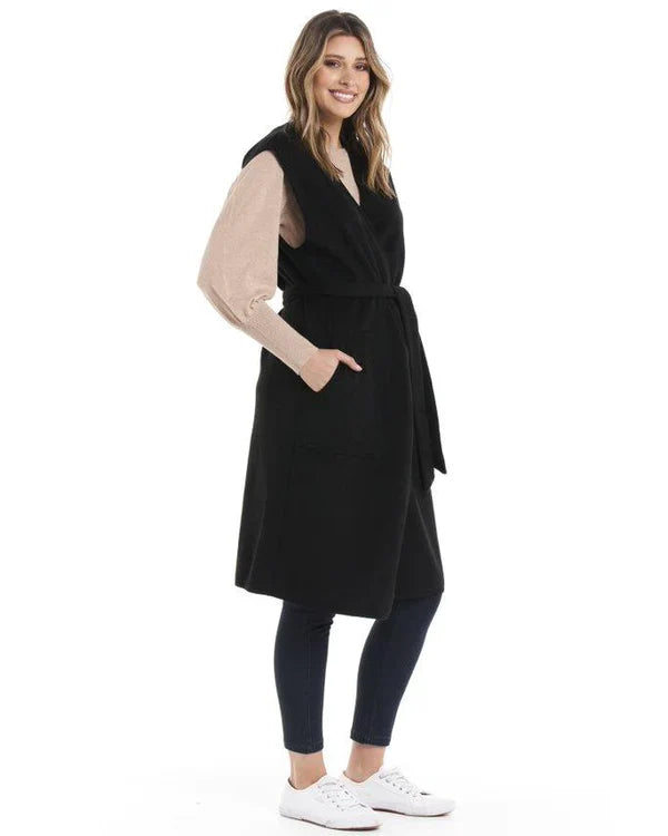 Alica Belted Sleeveless Coat - Black | Betty Basics | Are you ready to add a touch of elegance to your autumnal layering game? Look no further than the Alicia Belted Sleeveless Coat! This piece is the perfect combinatio