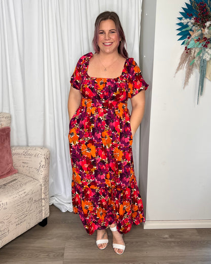 Yasmin Midi Dress - Berry Floral | Sass Clothing | Introducing the Yasmin Frill Hem Midi Dress! With its flirty frill hem and elasticated square neckline, it exudes confidence and grace. The back shirred panel ensure