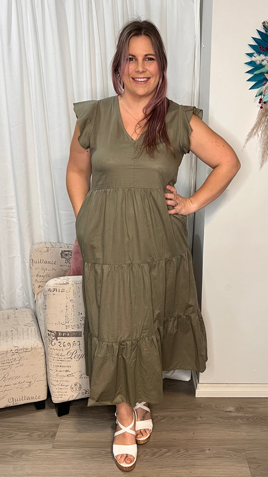 Kelsea Tiered Dress: 
Step out in style with the Kelsea Tiered Midi Dress - the perfect blend of comfort and sophistication. This dress features flutter sleeves, a tiered skirt, and a fl - Ciao Bella Dresses 
