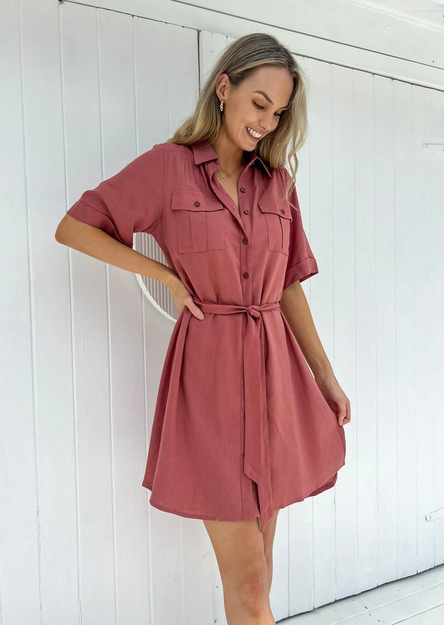 Aspen Dress: 
The Aspen Dress is a versatile shirt dress made from 100% cotton. With a matching belt and convenient pockets, this short dress features a chic high-low hem and is  - Ciao Bella Dresses - Mylk the Label