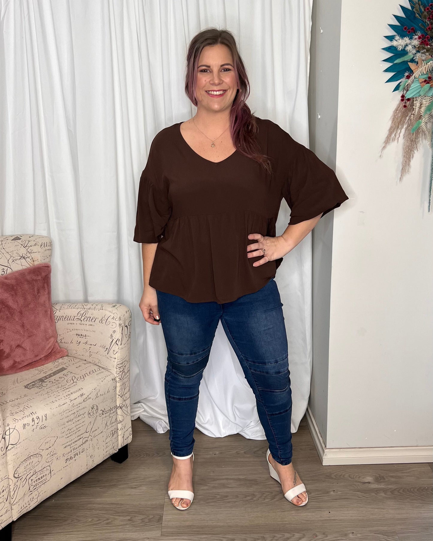 Yasmin Bubble Sleeve Top - Brown | Sass Clothing |  
With its trendy V-neckline and dropped shoulder into bubble sleeves, this top exudes effortless style. The relaxed fit offers ultimate comfort, while the back keyh