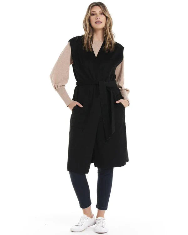 Alica Belted Sleeveless Coat - Black | Betty Basics | Are you ready to add a touch of elegance to your autumnal layering game? Look no further than the Alicia Belted Sleeveless Coat! This piece is the perfect combinatio