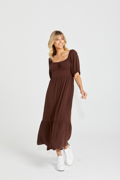 Yasmin Midi Dress - Brown | Sass Clothing | Introducing the Yasmin Frill Hem Midi Dress! With its flirty frill hem and elasticated square neckline, it exudes confidence and grace. The back shirred panel ensure