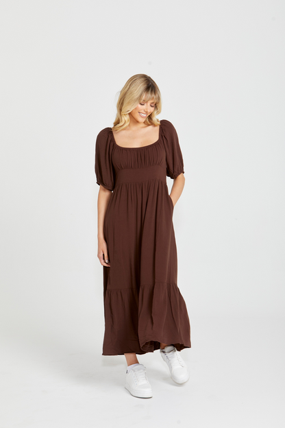 Yasmin Midi Dress - Brown | Sass Clothing | Introducing the Yasmin Frill Hem Midi Dress! With its flirty frill hem and elasticated square neckline, it exudes confidence and grace. The back shirred panel ensure