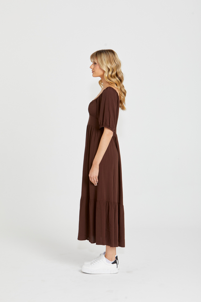 Yasmin Midi Dress - Brown | Sass Clothing | Introducing the Yasmin Frill Hem Midi Dress! With its flirty frill hem and elasticated square neckline, it exudes confidence and grace. The back shirred panel ensure