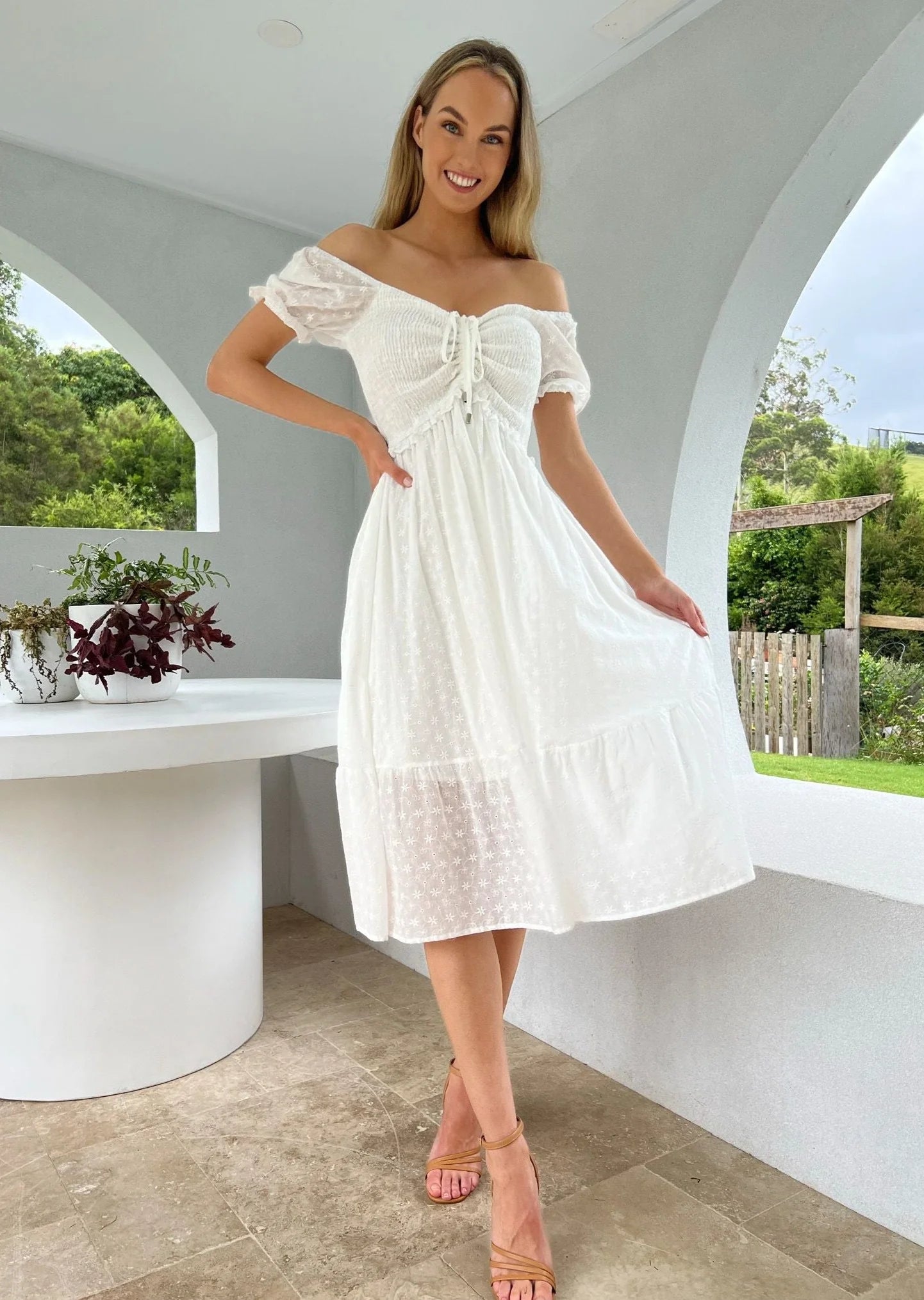 Addalyn Midi Dress: The Addalyn Midi Dress in white anglaise is a versatile piece that can be worn on or off the shoulder. Its rouched bust and midi length create a chic and feminine si - Ciao Bella Dresses 