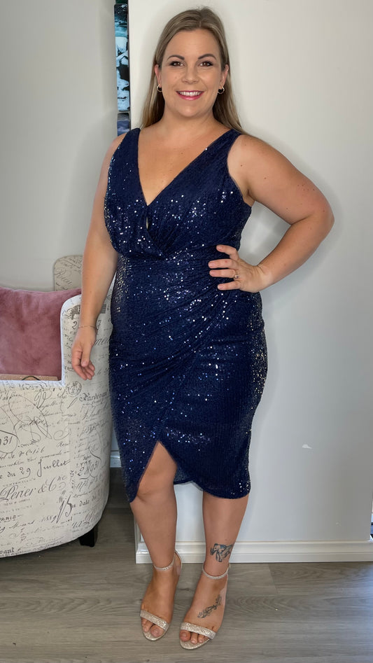 
Be the life of the party in our Kim v-wrap sequin midi! Get in a bit of glam with these glitzy sequins paired with a stunning wrap skirt. It's the perfect dress for - Kim Sequin Dress - Navy - Lumier by Bariano