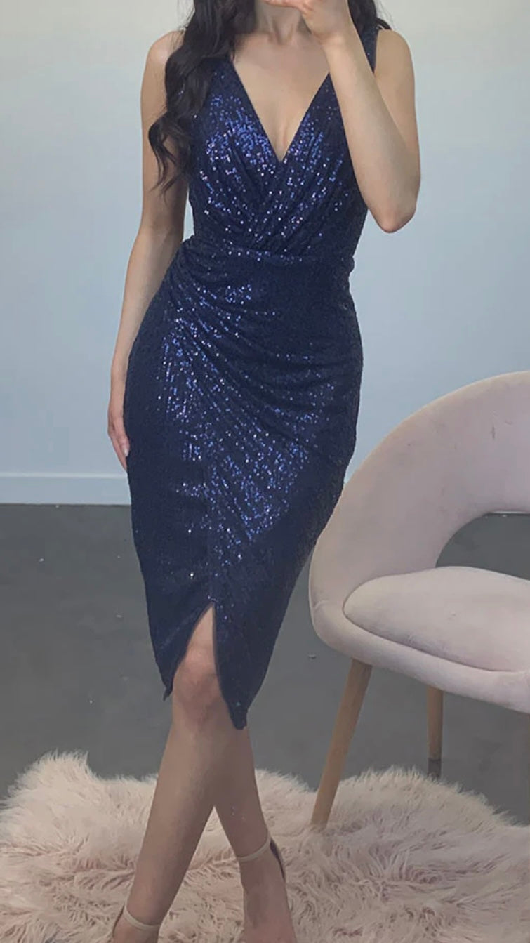 
Be the life of the party in our Kim v-wrap sequin midi! Get in a bit of glam with these glitzy sequins paired with a stunning wrap skirt. It's the perfect dress for - Kim Sequin Dress - Navy - Lumier by Bariano