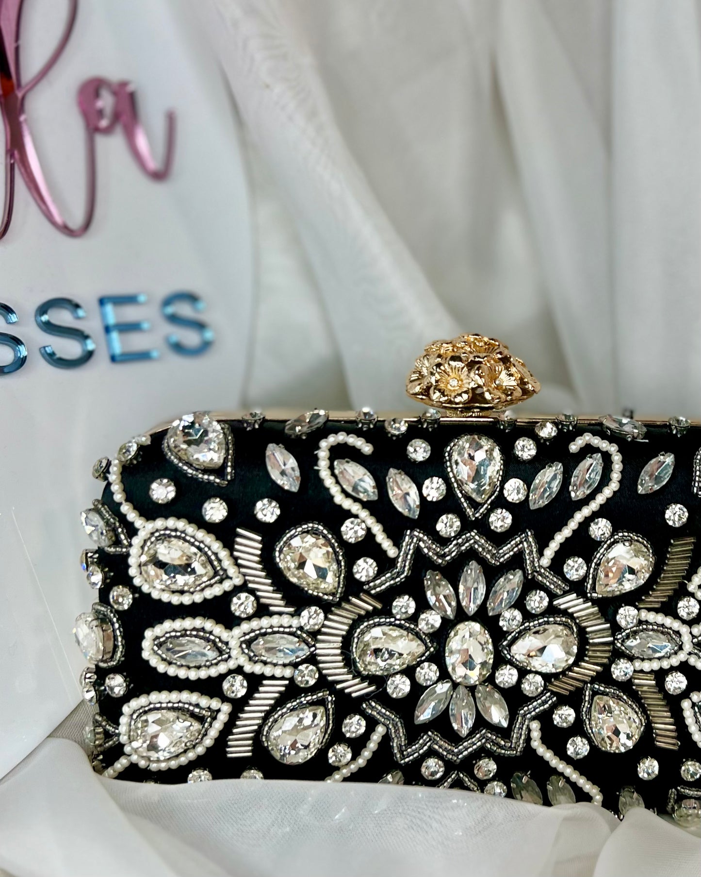 Elana Evening Bag | Tripp Australia | This stunning piece will bring together your evening outfit with it’s gorgeous pops of bling against a contrasting black satin background
Features:

Interchangable c